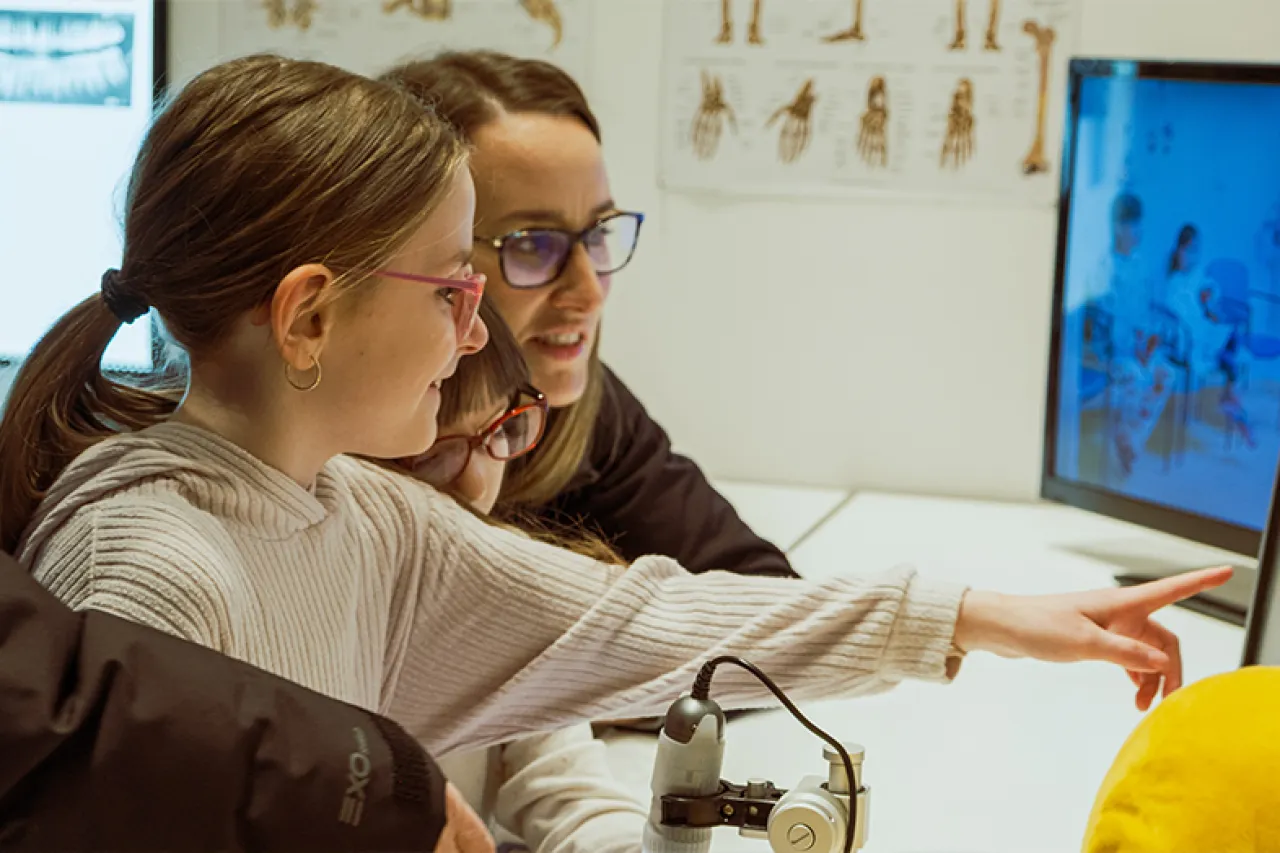 Child with parents interacting with indoor exhibit.
