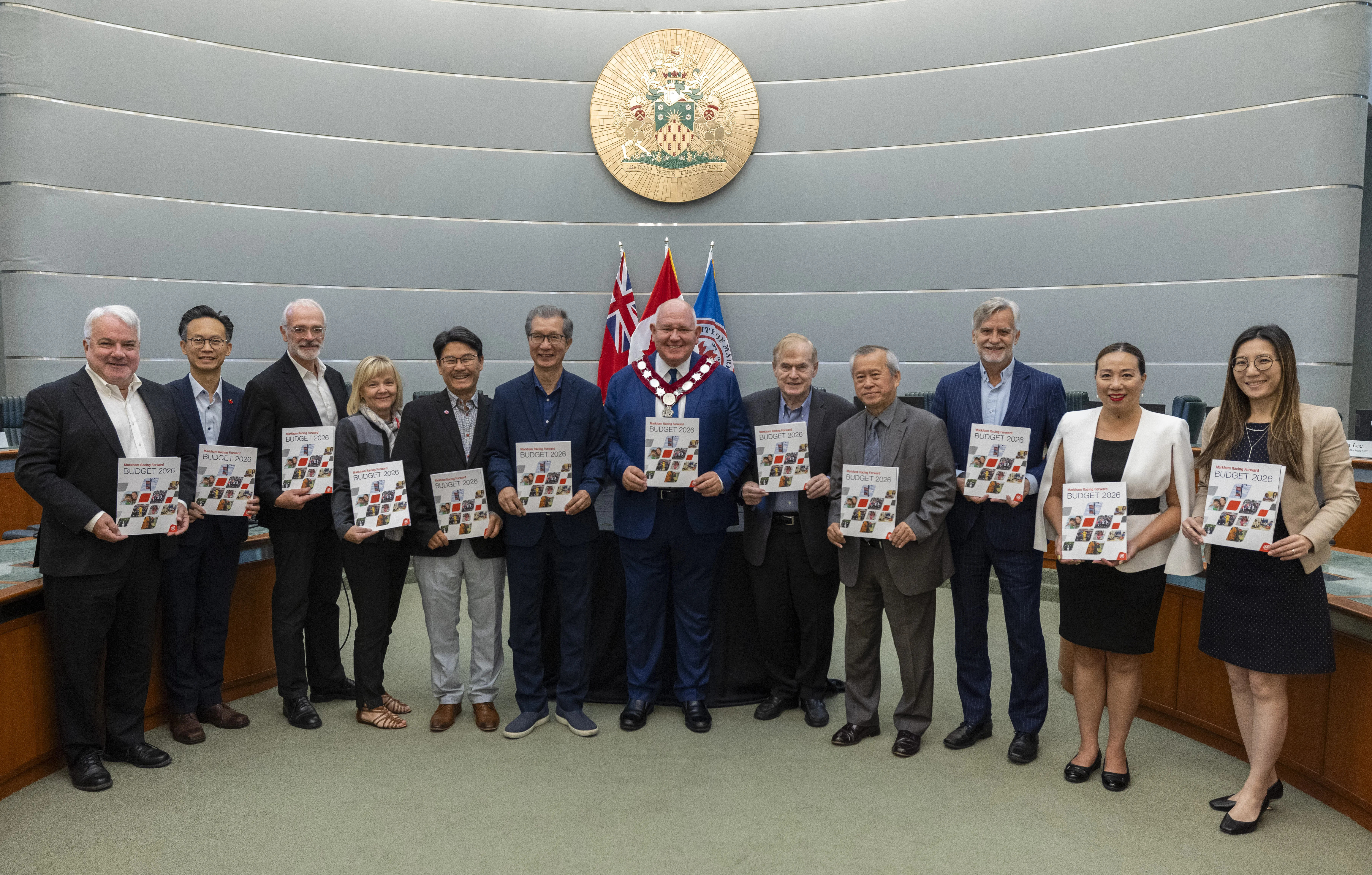 City of Markham's Mayor and councilors holding 2026 budget booklets.