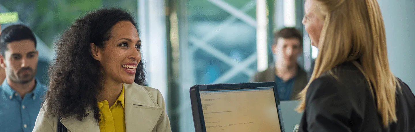 Person talking to receptionist.