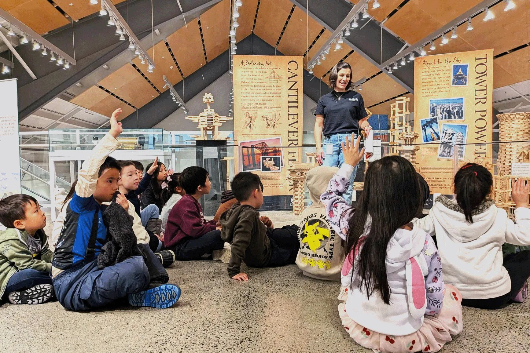 Children seated around an exhibit.
